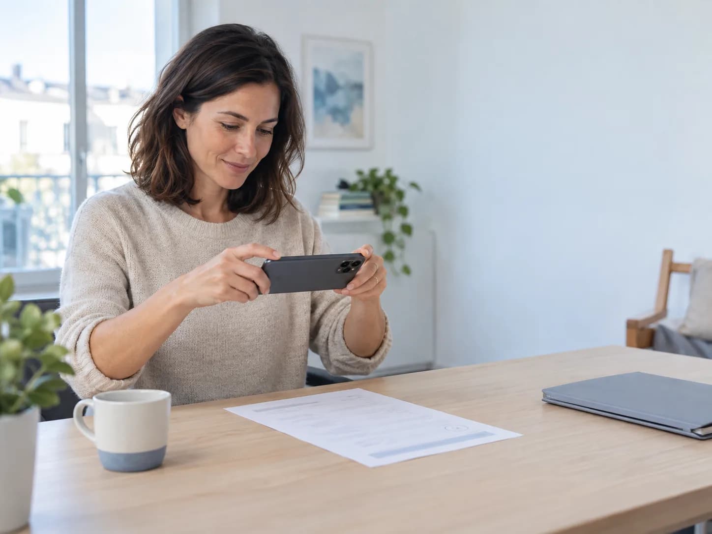 A person photographing a paper medical document with a smartphone at home